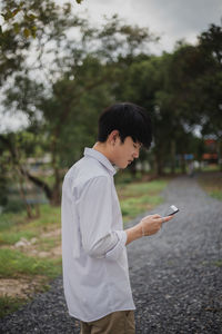 Side view of man using mobile phone