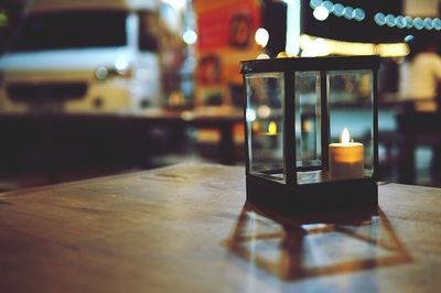 Close-up of illuminated candles on table