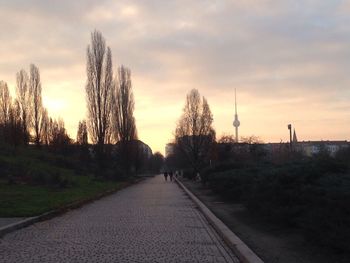 Road against cloudy sky at sunset