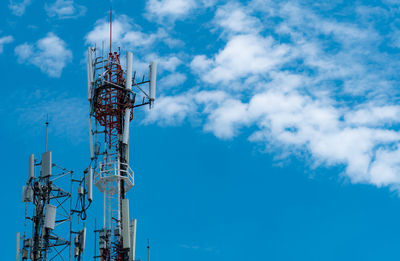 Telecommunication tower with blue sky and white clouds background. antenna on blue sky. 