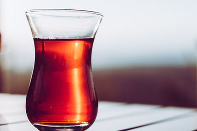 Close-up of red drink in glass on table