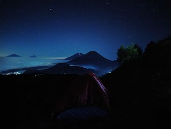 Panoramic view of illuminated mountain against sky at night