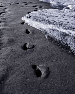 High angle view of footprints on beach