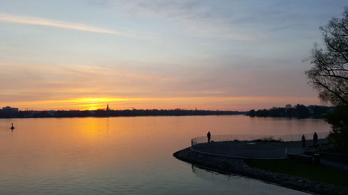 Scenic view of lake against sky during sunset