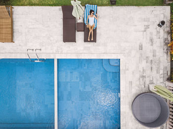 Aerial view of attractive woman near the pool at resort