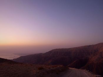 Scenic view of dramatic landscape against sky during sunset