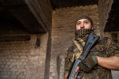 Portrait of serious middle eastern man with ak-47