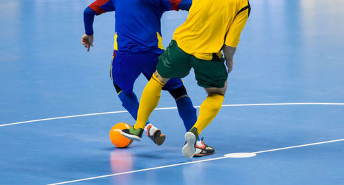 Low section of men playing soccer