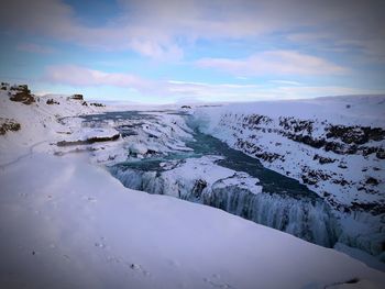 Scenic view of frozen landscape against sky