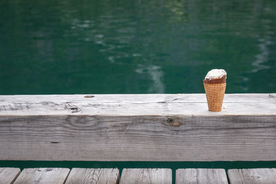Ice cream cone on pier by lake