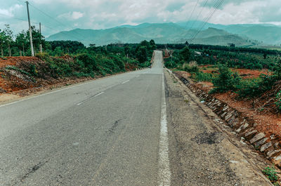 Empty road along countryside landscape