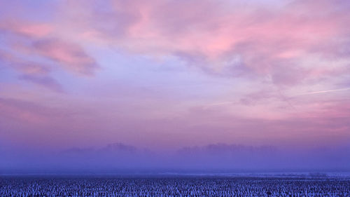 Scenic view of cloudy sky at sunset