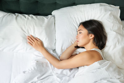 Young woman sleeping on bed at home