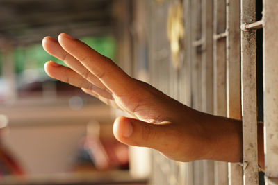 Close-up of human hand touching mirror