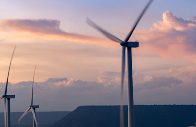 Low angle view of windmill against sky during sunset