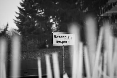 Close-up of road sign against trees