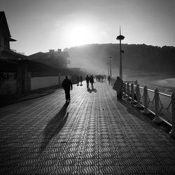 Rear view of people walking on footpath