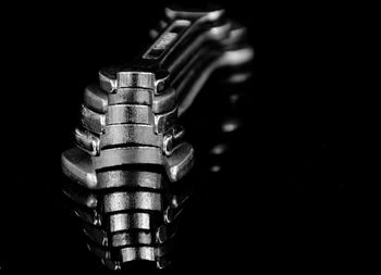 Close-up of machine part against black background