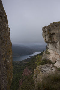 Scenic view of sea and mountains against clear sky