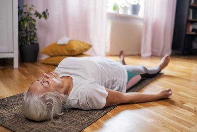 Young woman lying on bed at home