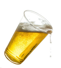 Close-up of beer glass against white background