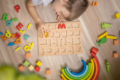 High angle view of woman with toy blocks on table