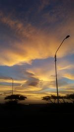 Low angle view of silhouette windmill against sky during sunset