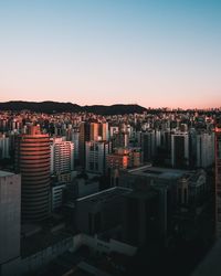 High angle view of buildings against clear sky during sunset