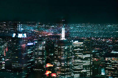 Aerial view of city lit up at night