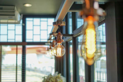 Close-up of illuminated light bulb at cafe