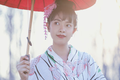 Portrait of cute girl holding camera