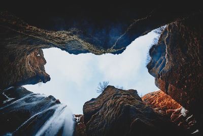 Low angle view of rock formation against sky