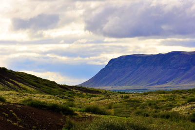 Scenic view of mountains against cloudy sky