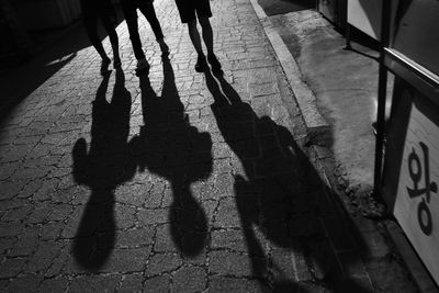 Shadow of people on footpath