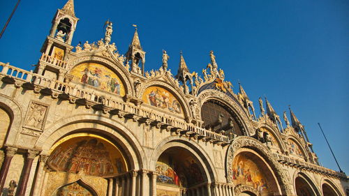 Low angle view of historical building against blue sky