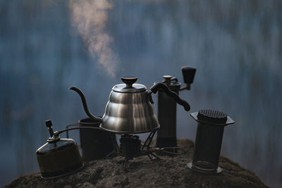 Boiling kettle and coffee or tea accessories in the evening or morning in the woods