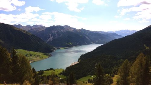 Scenic view of lake and mountains against sky