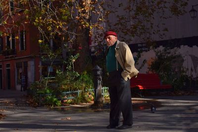 Man standing by tree against plants