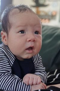 Close-up of cute baby boy at home