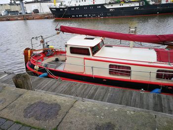 High angle view of red boat moored at riverbank