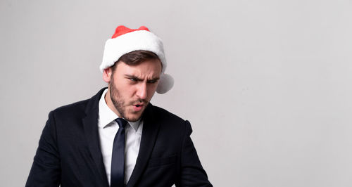 Mid adult man wearing hat against white background