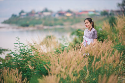 Young woman standing on field