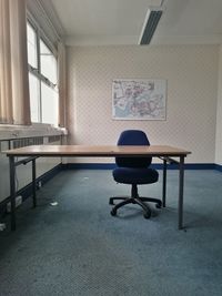 Empty chair with table in office