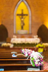 Vases on pews in church