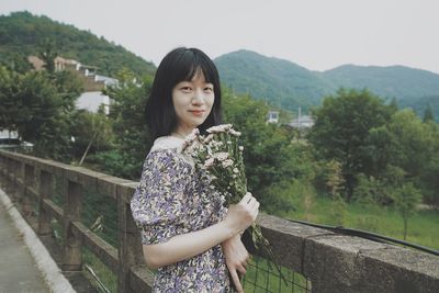 Portrait of beautiful woman standing on mountain