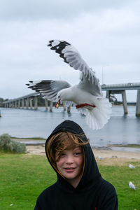 Portrait of young woman standing on field