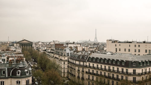 High angle view of buildings in town against sky