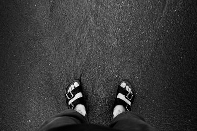 Low section of man standing on street