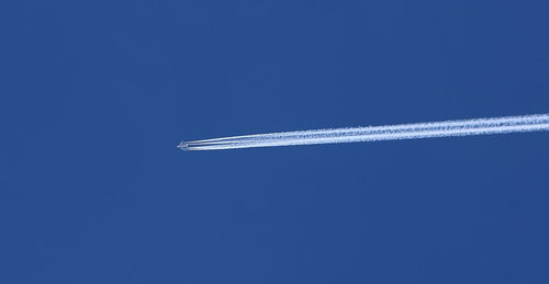 Airplane flying against clear blue sky