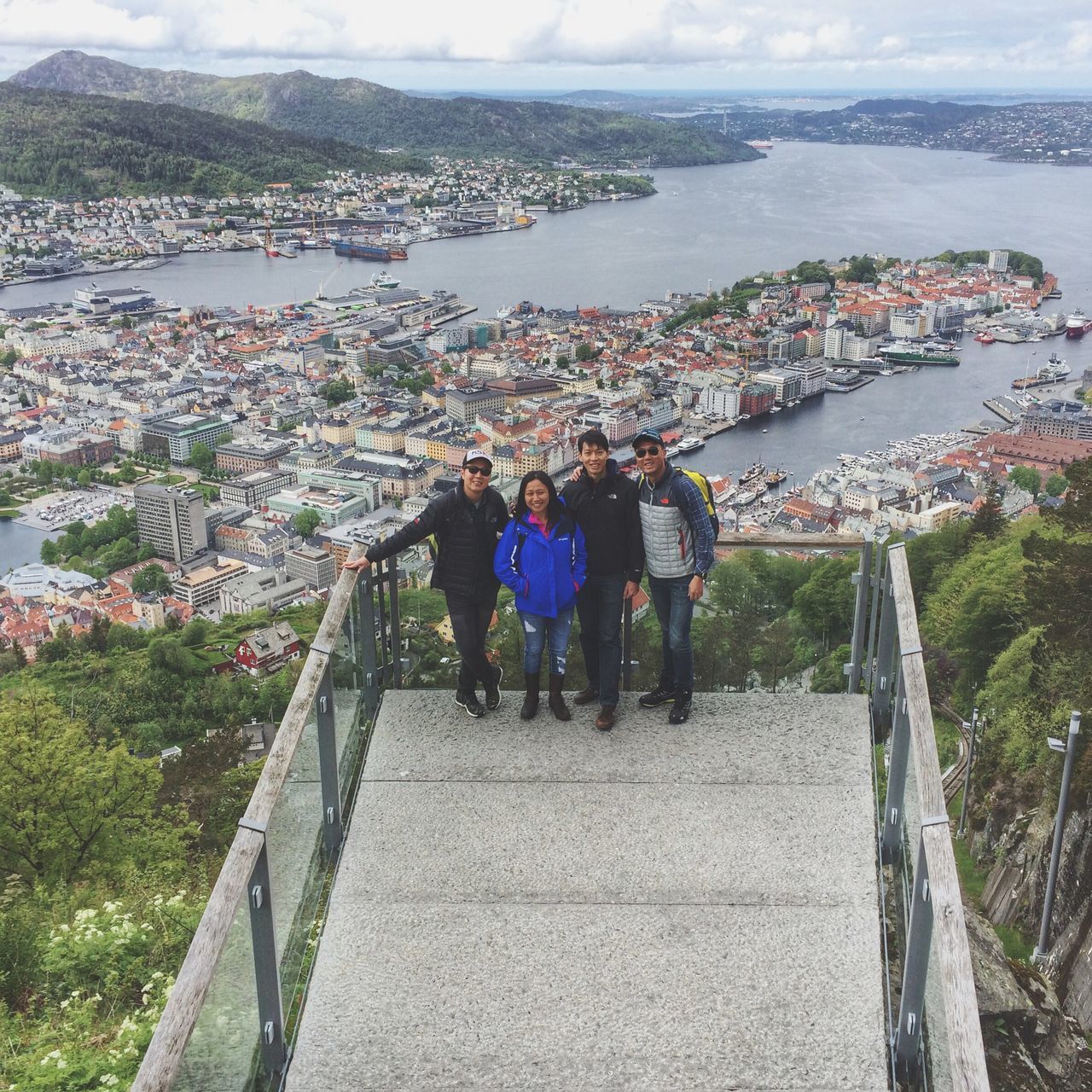 lifestyles, water, leisure activity, person, mountain, railing, men, sea, rear view, high angle view, built structure, architecture, pier, large group of people, sky, walking, togetherness, river, nature